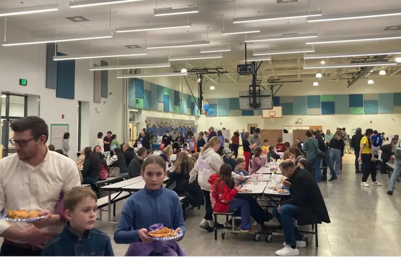 Families filling the cafeteria for a PTO evening event