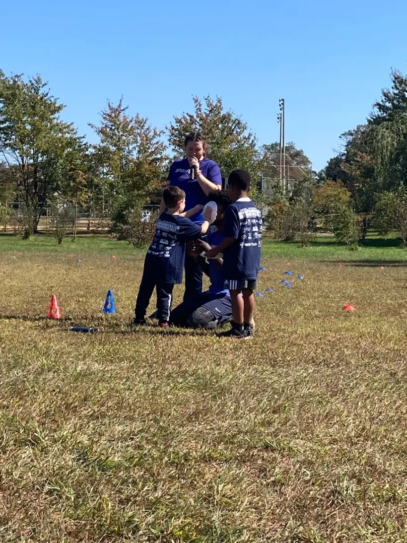 A team of students huddled together on the field