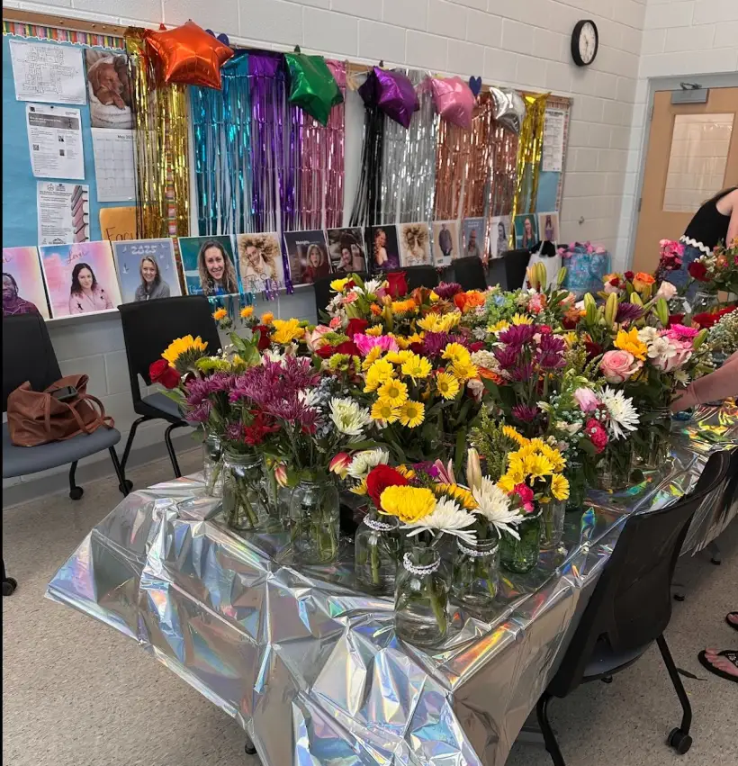 A table of fresh flower bouquets laid out for staff during Teacher Appreciation Week