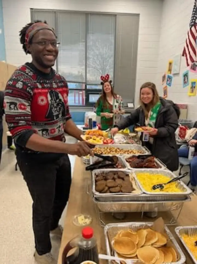 Staff serving themselves from a buffet during appreciation week